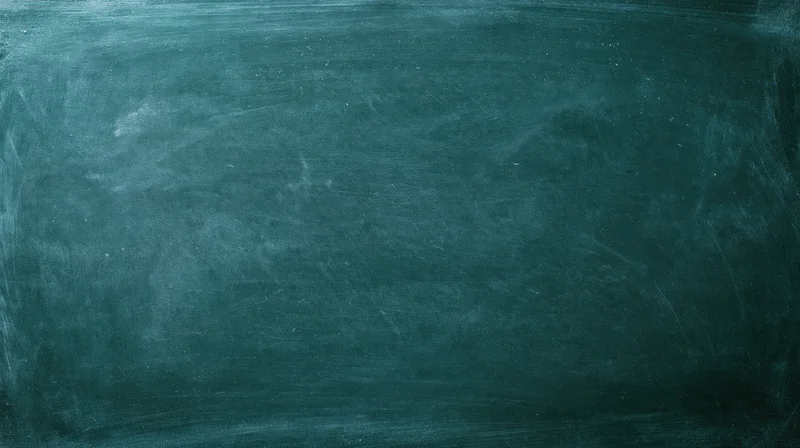 Close-up of a worn dark green chalkboard surface with smudged chalk residue and scratches