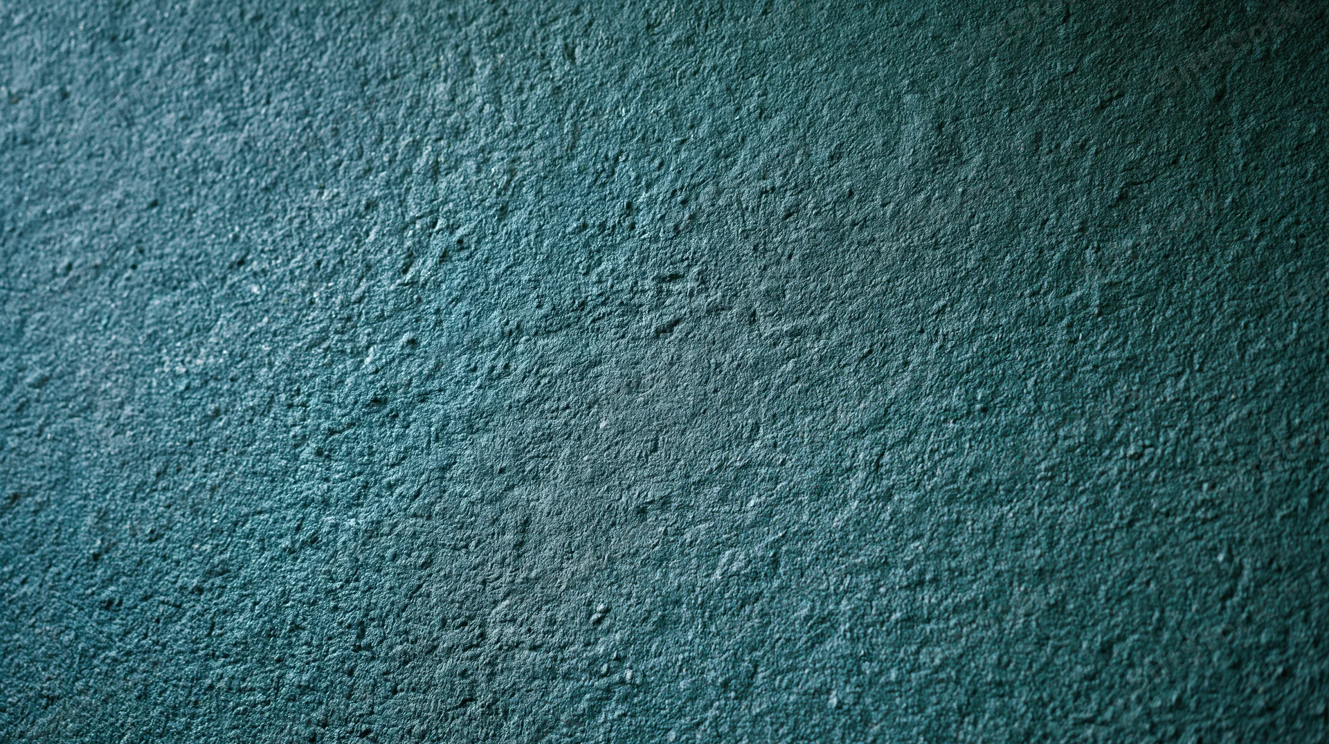 Close-up of rough textured concrete wall surface with blue-gray tone