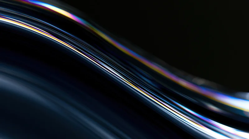 Flowing dark glass surface with iridescent light reflections in close-up macro view