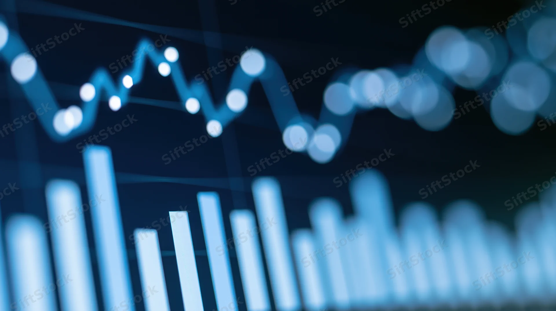 Glowing digital bar chart and line graph on a dark screen displaying data trends