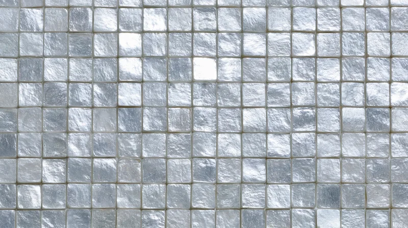 Close-up of silver mosaic tiles arranged in a grid on a wall surface
