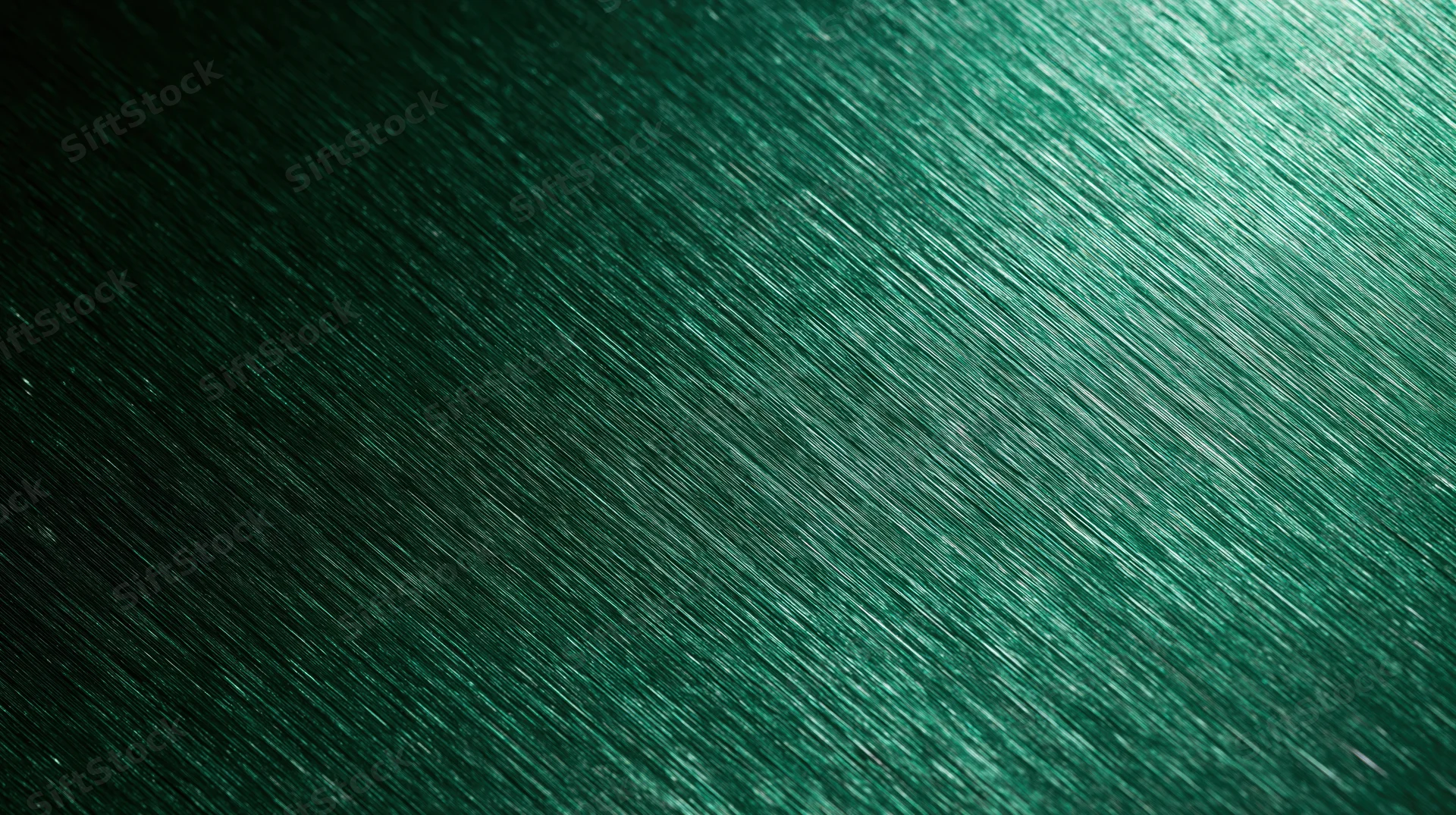Close-up of brushed green metallic surface with diagonal texture and reflective sheen