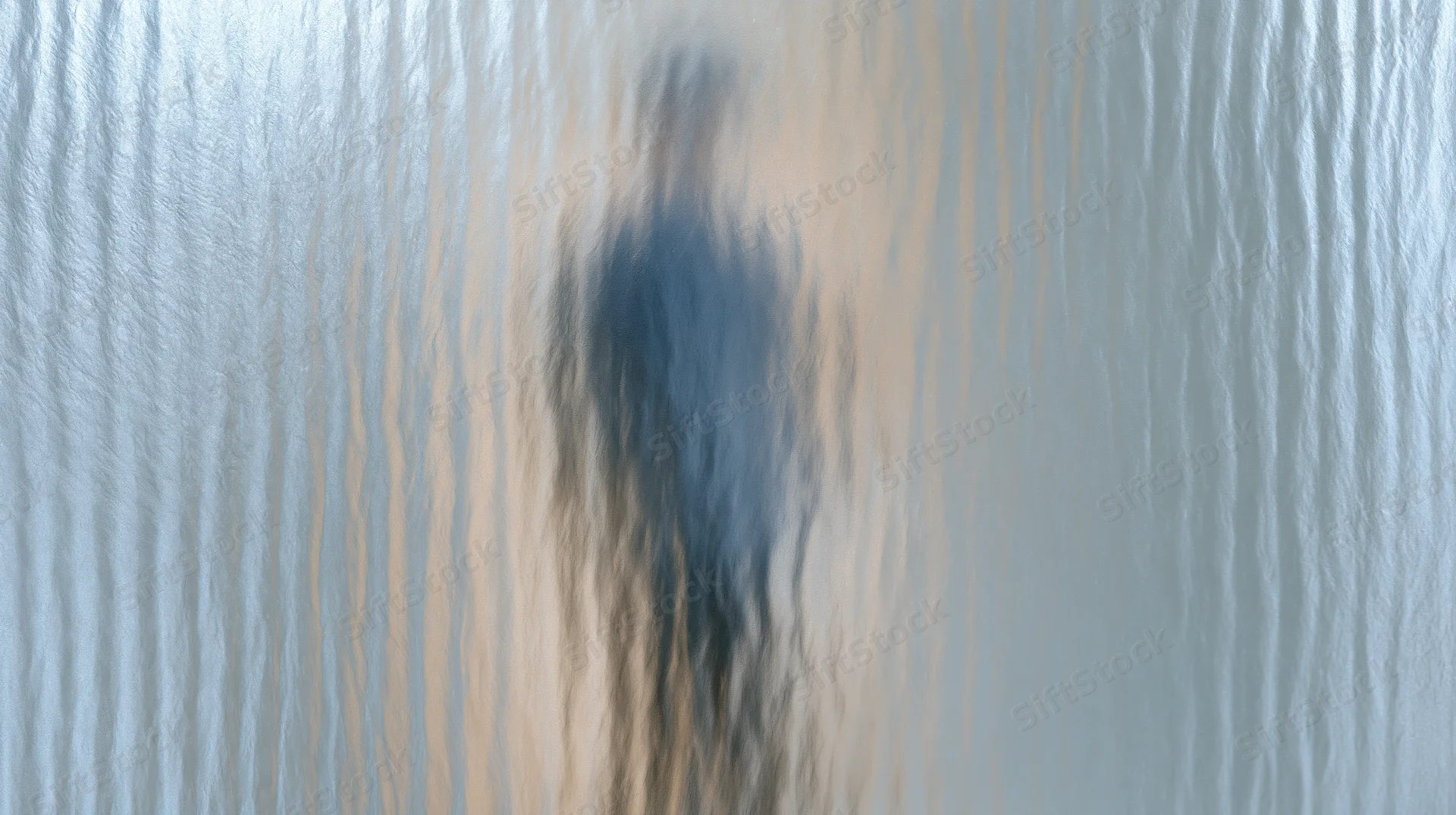 Blurred reflection on a ribbed reeded glass panel with vertical lines and light diffusion