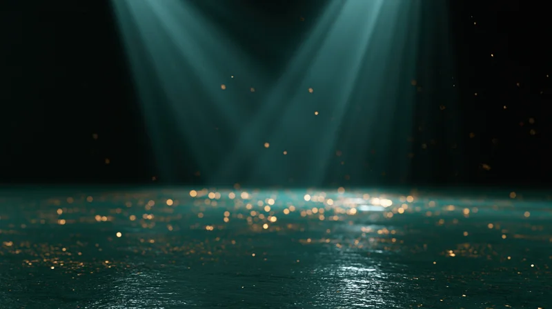 Dark stage floor reflecting teal-green theatrical spotlights with shimmering particles
