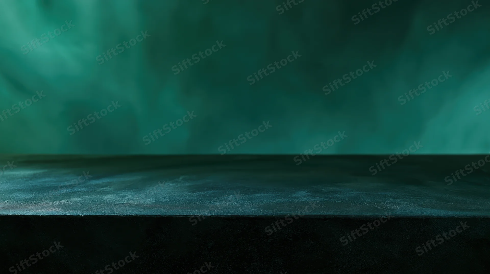 Dark matte concrete table surface in a smoky studio with green atmospheric lighting