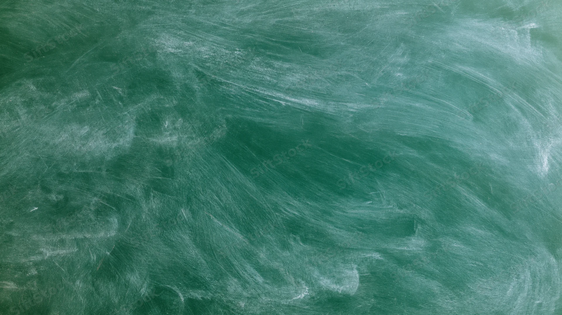 Green chalkboard surface with erased white chalk marks filling the frame