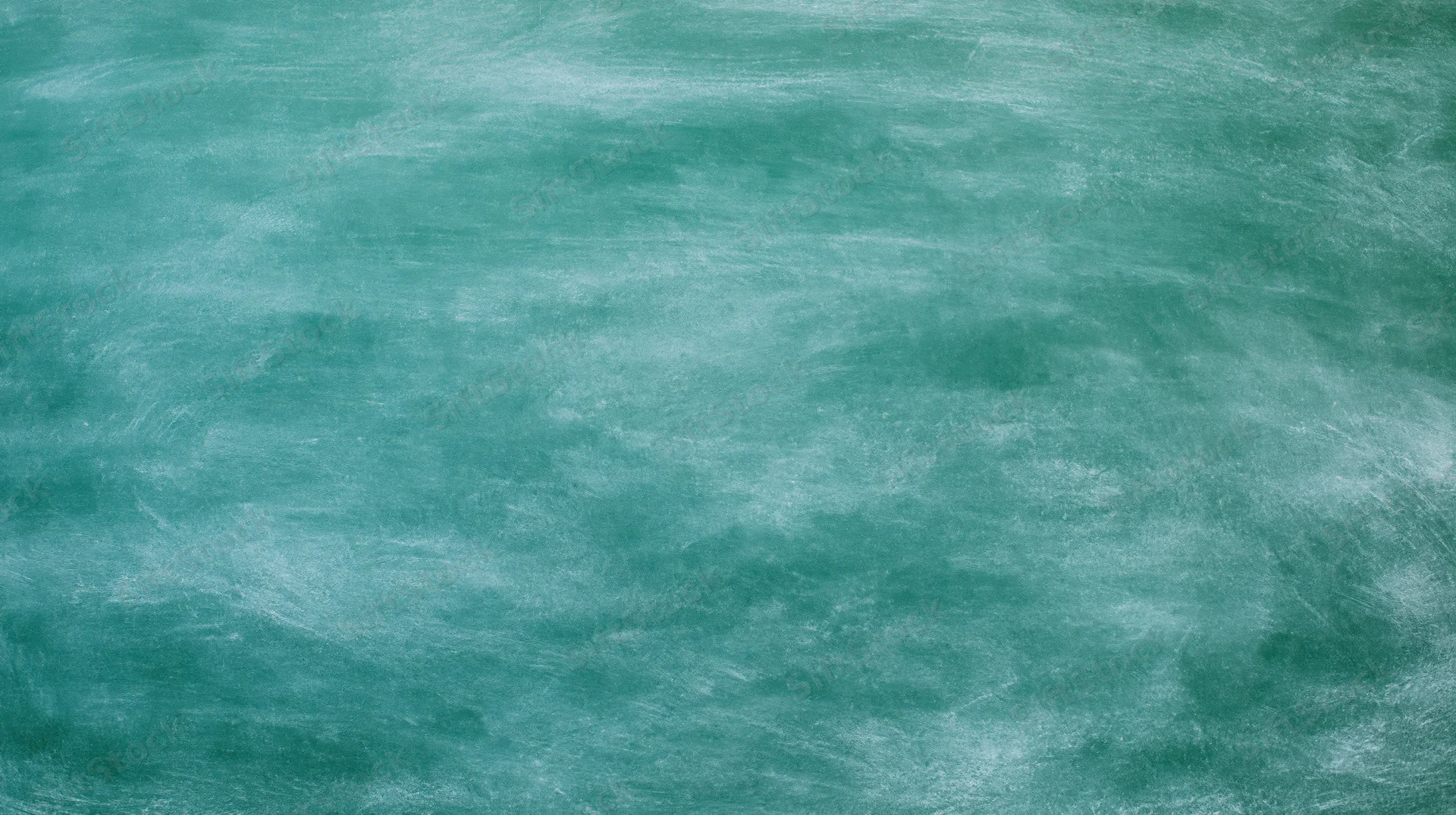 Green chalkboard surface filling the frame with visible texture and smudges