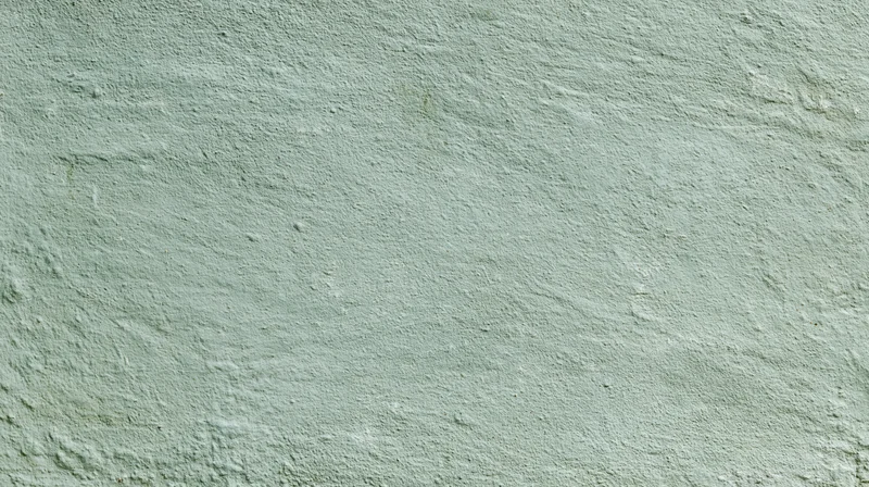 Textured painted concrete wall surface filling the frame
