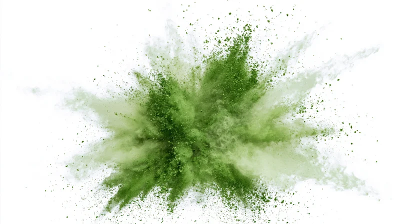 Green powder exploding outward in a burst against white background
