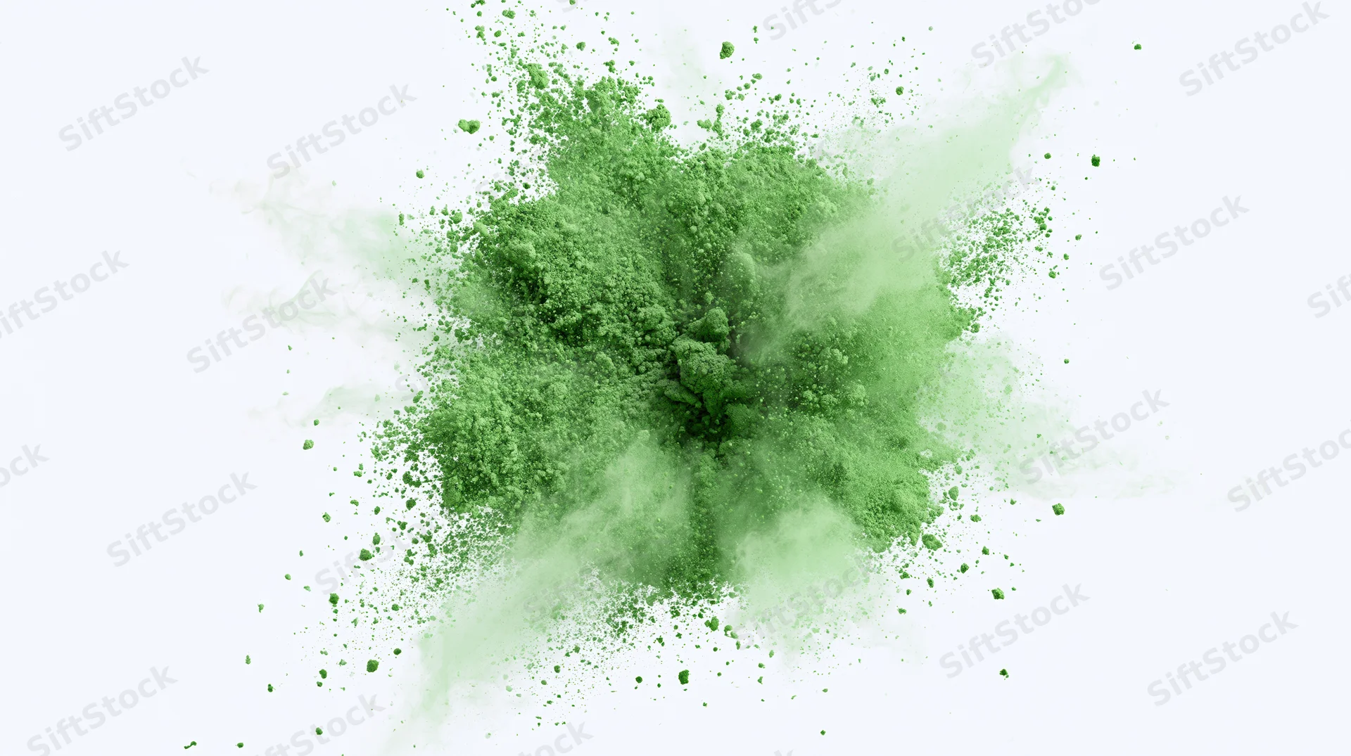Green powder exploding outward in a burst against a white background
