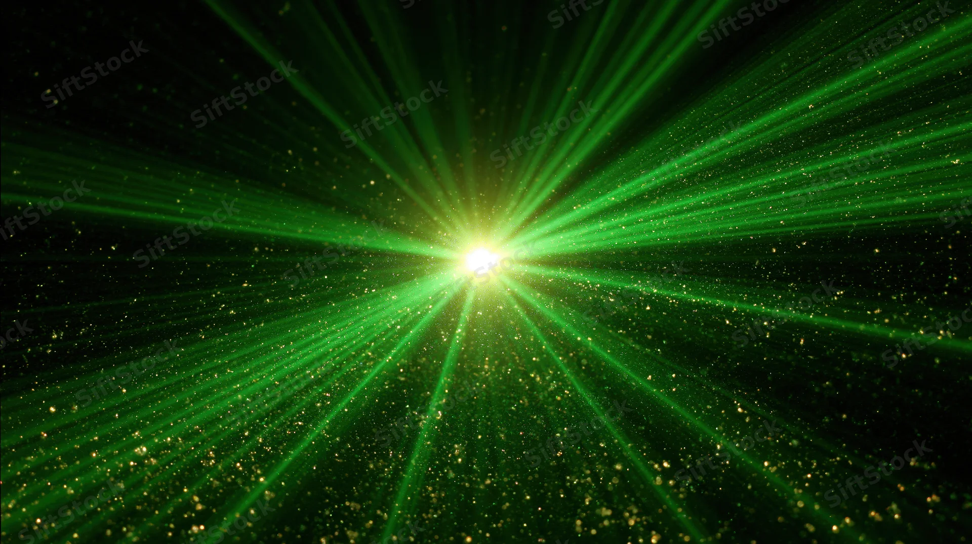 Green laser light burst radiating outward from a bright center in a dark space with sparkling particles