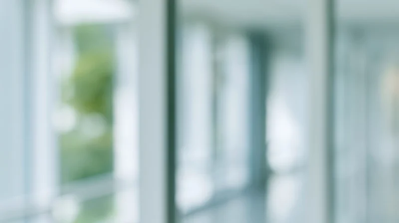 Blurred view through glass walls in a modern office corridor