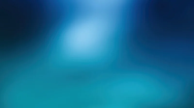 Smooth gradient of deep blue and teal tones forming an abstract blurred background