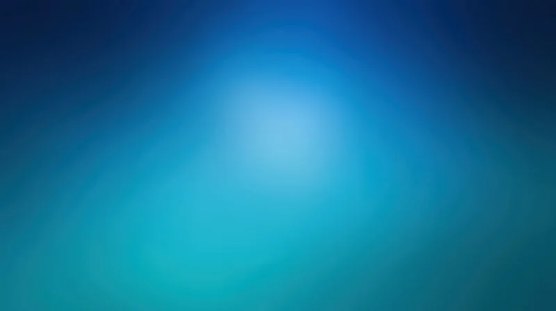 Smooth gradient of deep blue and teal tones forming a blurred abstract background