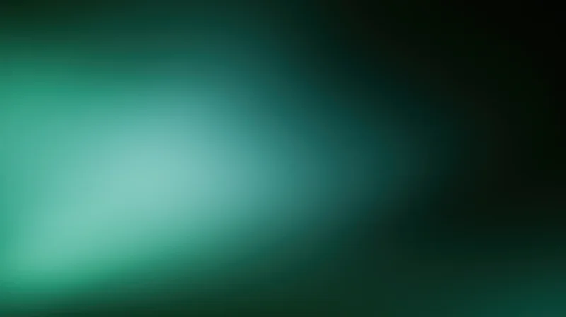 Soft defocused green gradient background with light bloom effect