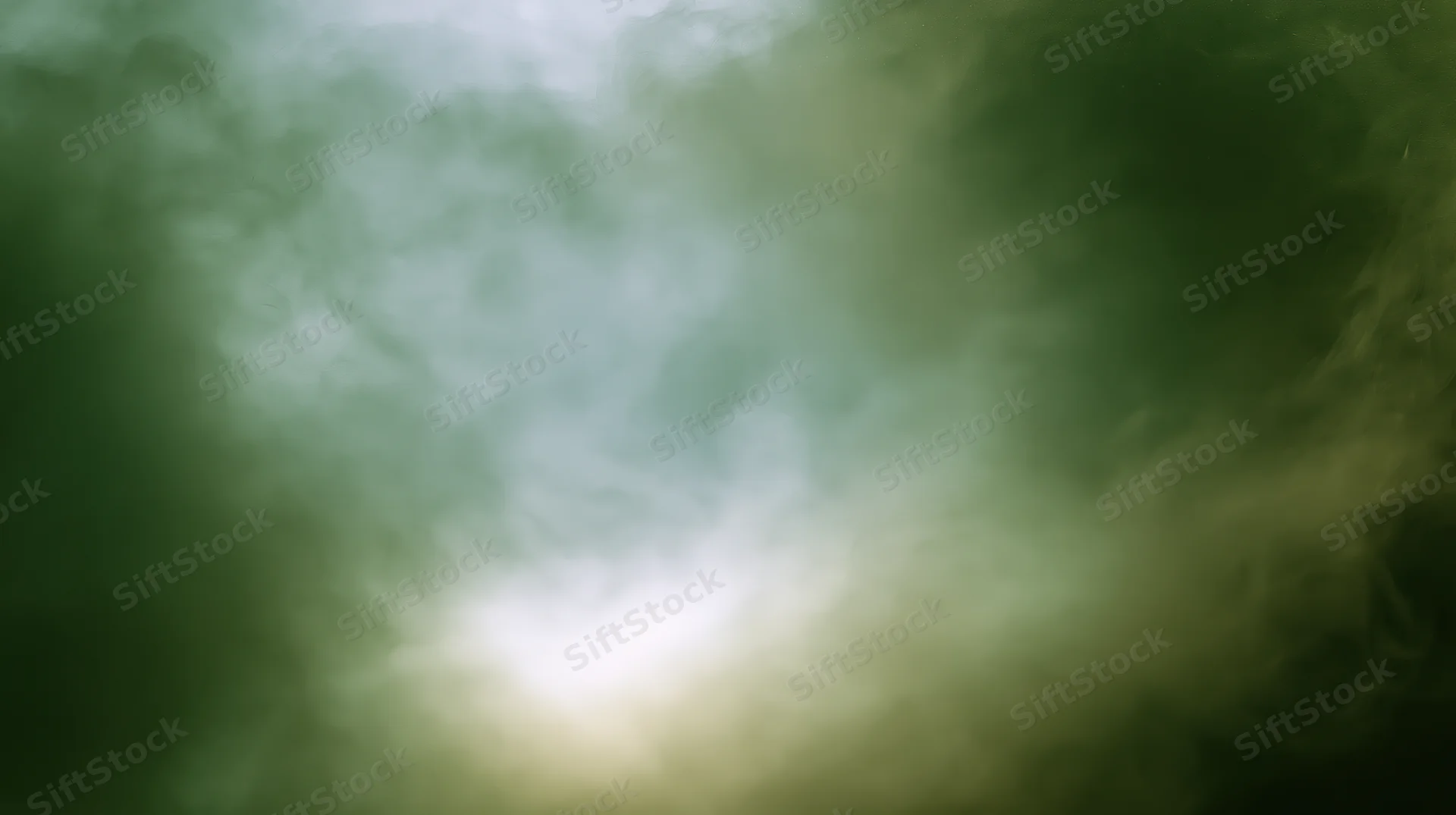 Swirling green-tinted smoke drifting across a plain background with a bright light source at center
