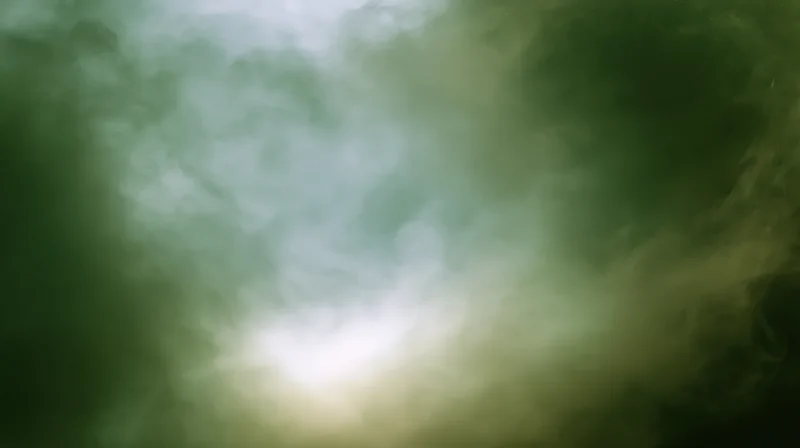Swirling green-tinted smoke drifting across a plain background with a bright light source at center