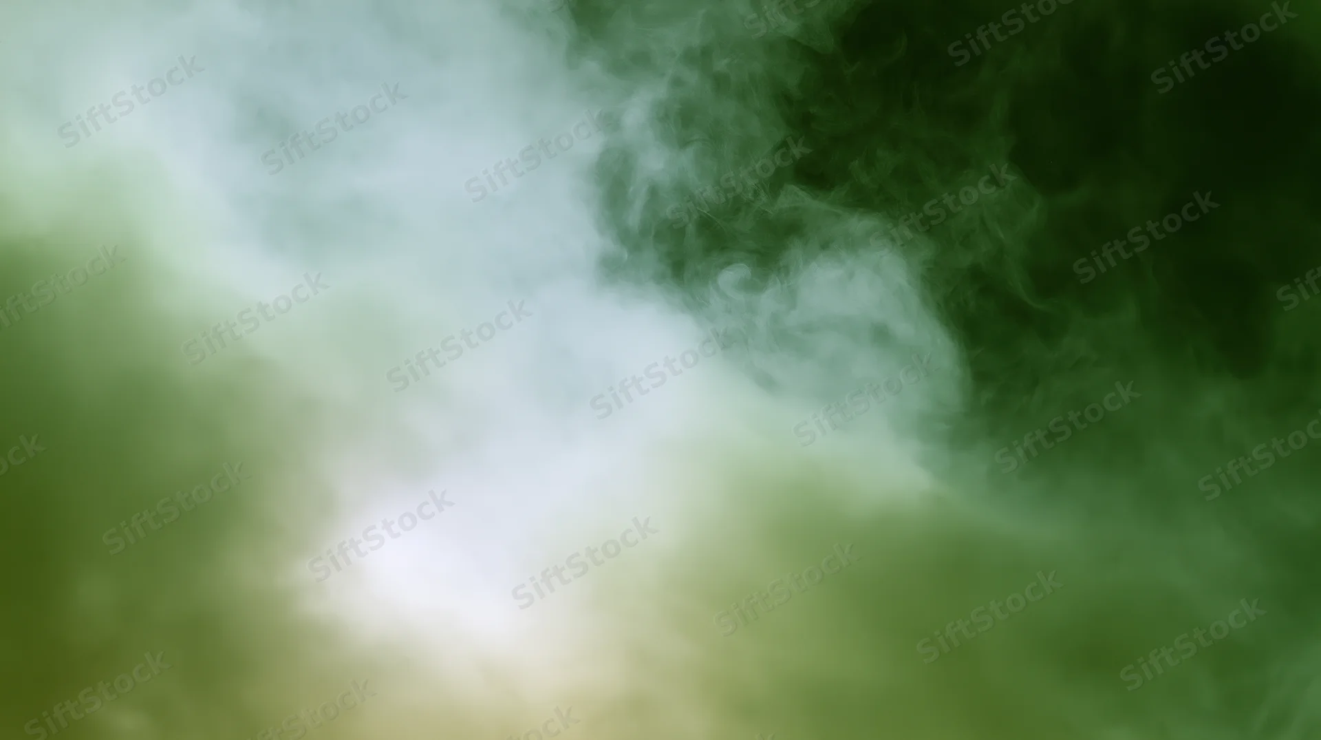Swirling green-tinted smoke drifting across a plain background with soft light glow