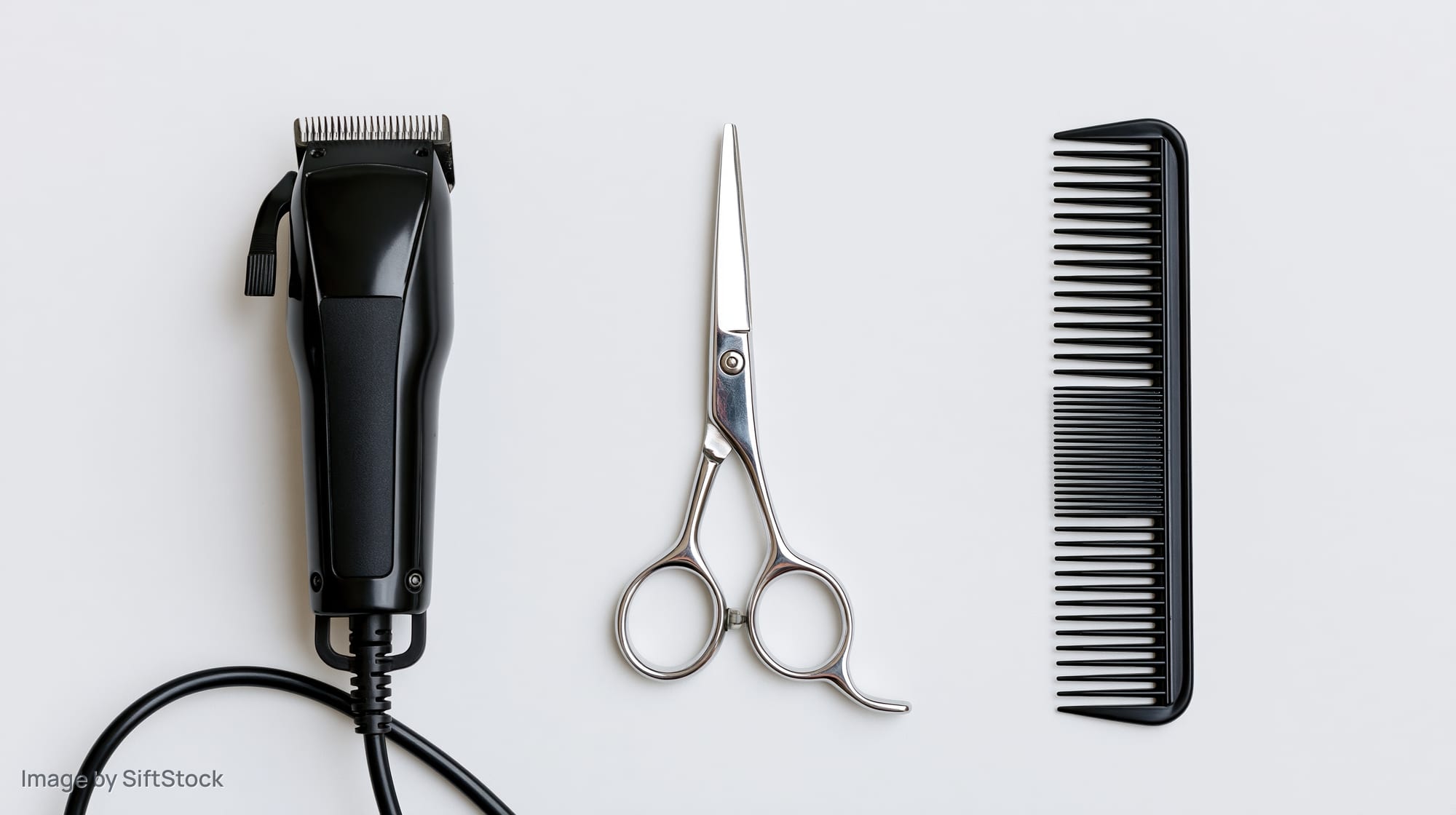 Barber tools arranged in a row on a white background