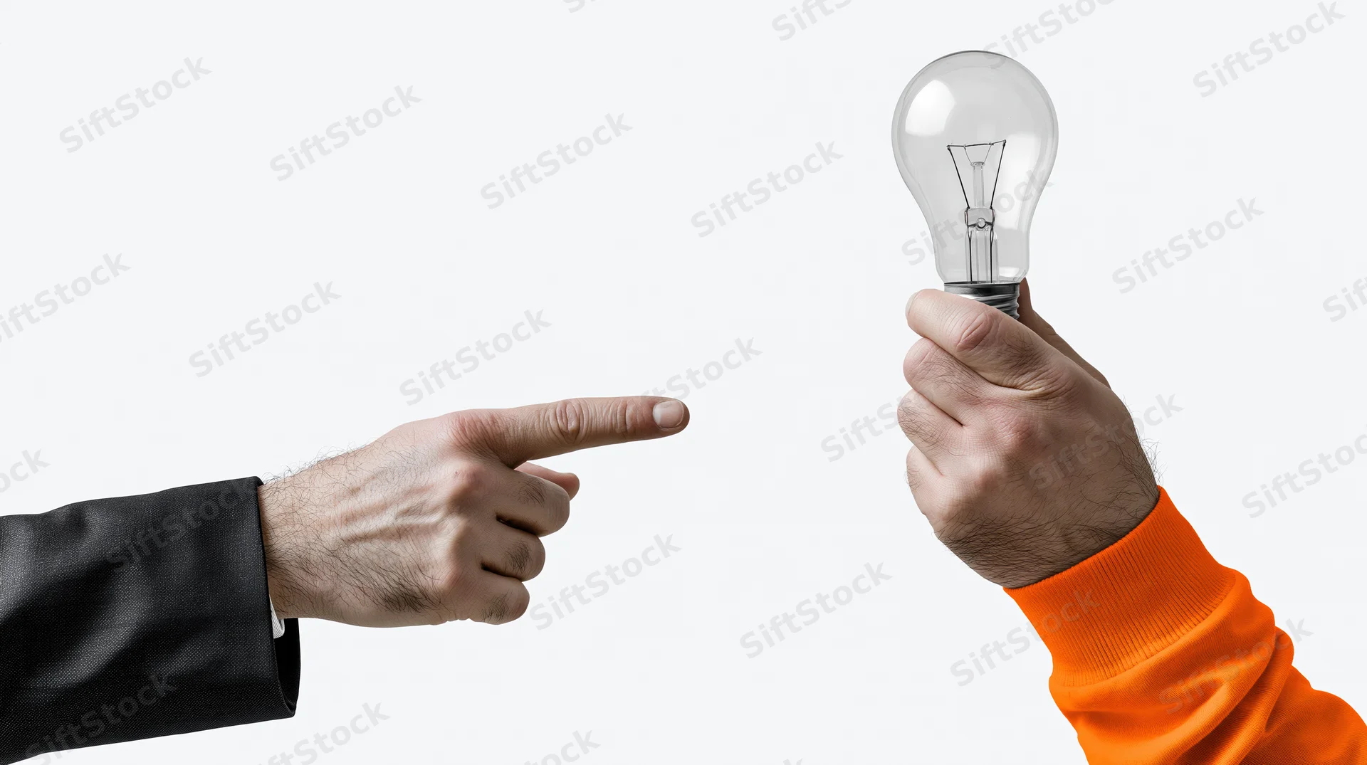 One hand in a suit sleeve pointing at another hand holding a lightbulb against a white background