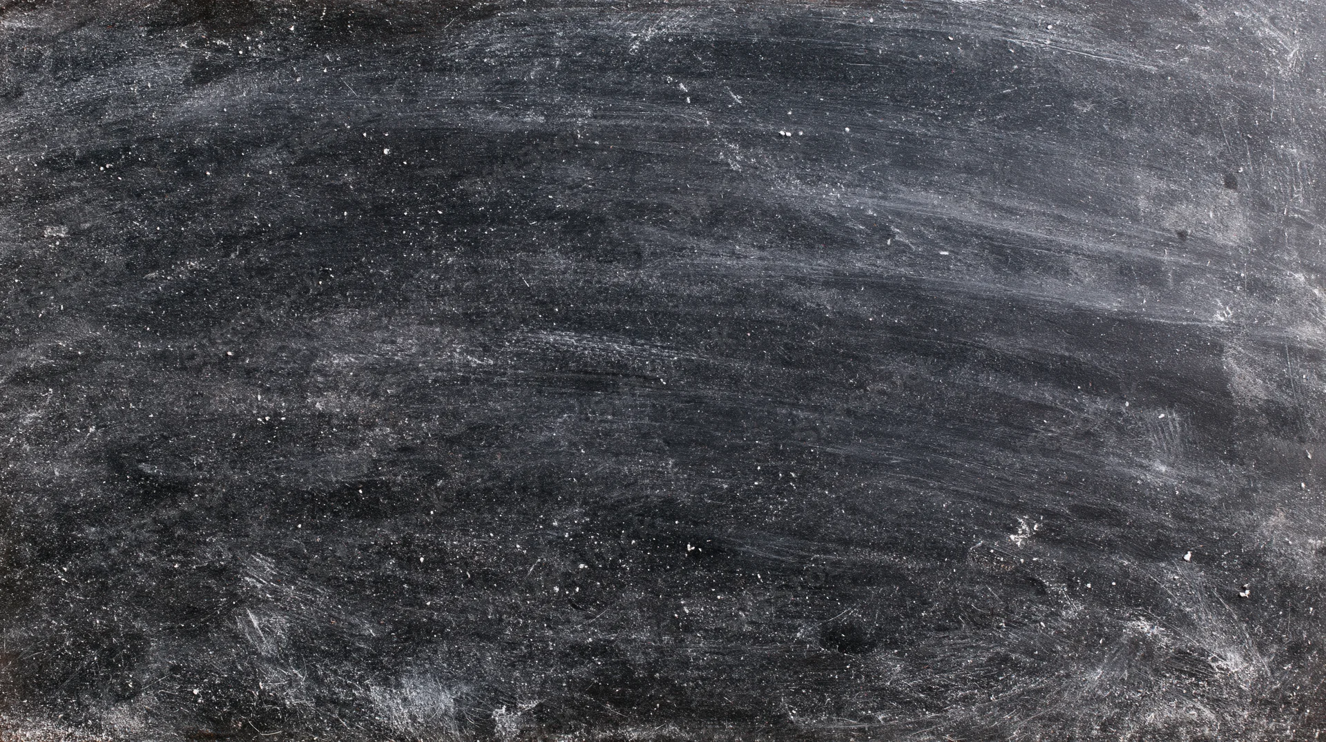 Worn blackboard surface with chalk residue and smudges, straight-on view