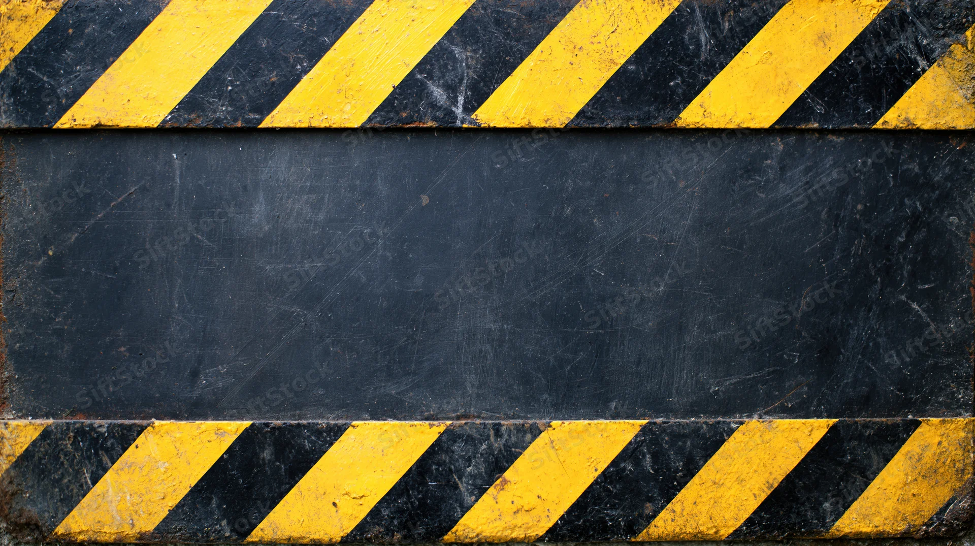 Worn industrial hazard warning surface with diagonal yellow and black stripes, central blank area for text
