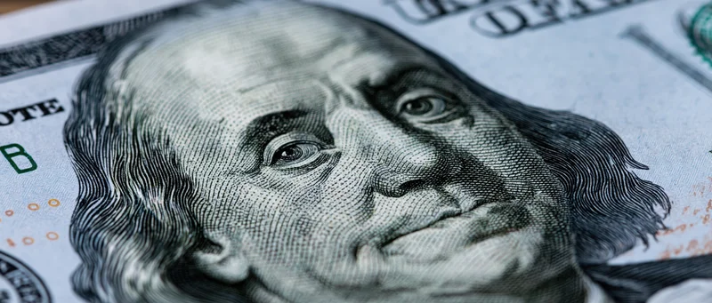 Closeup of benjamin franklin portrait on us hundred dollar bill