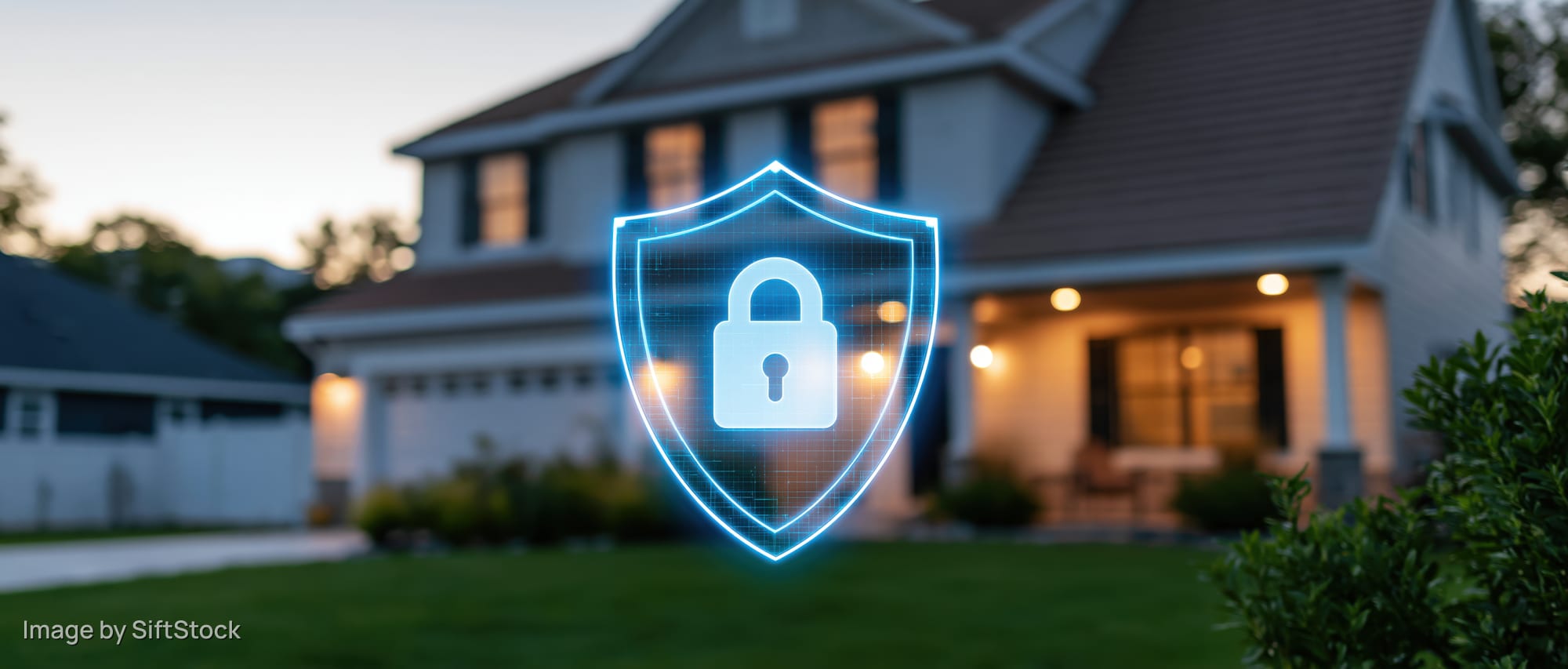 Glowing digital security shield with padlock icon over suburban house exterior at evening