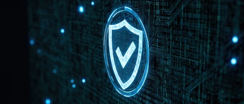 Glowing digital security shield with checkmark on circuit board background
