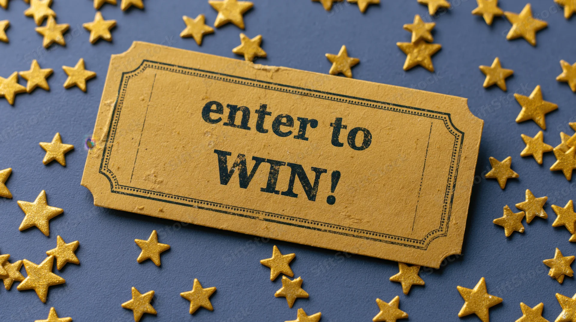 Golden raffle ticket reading enter to win on blue surface with scattered gold stars