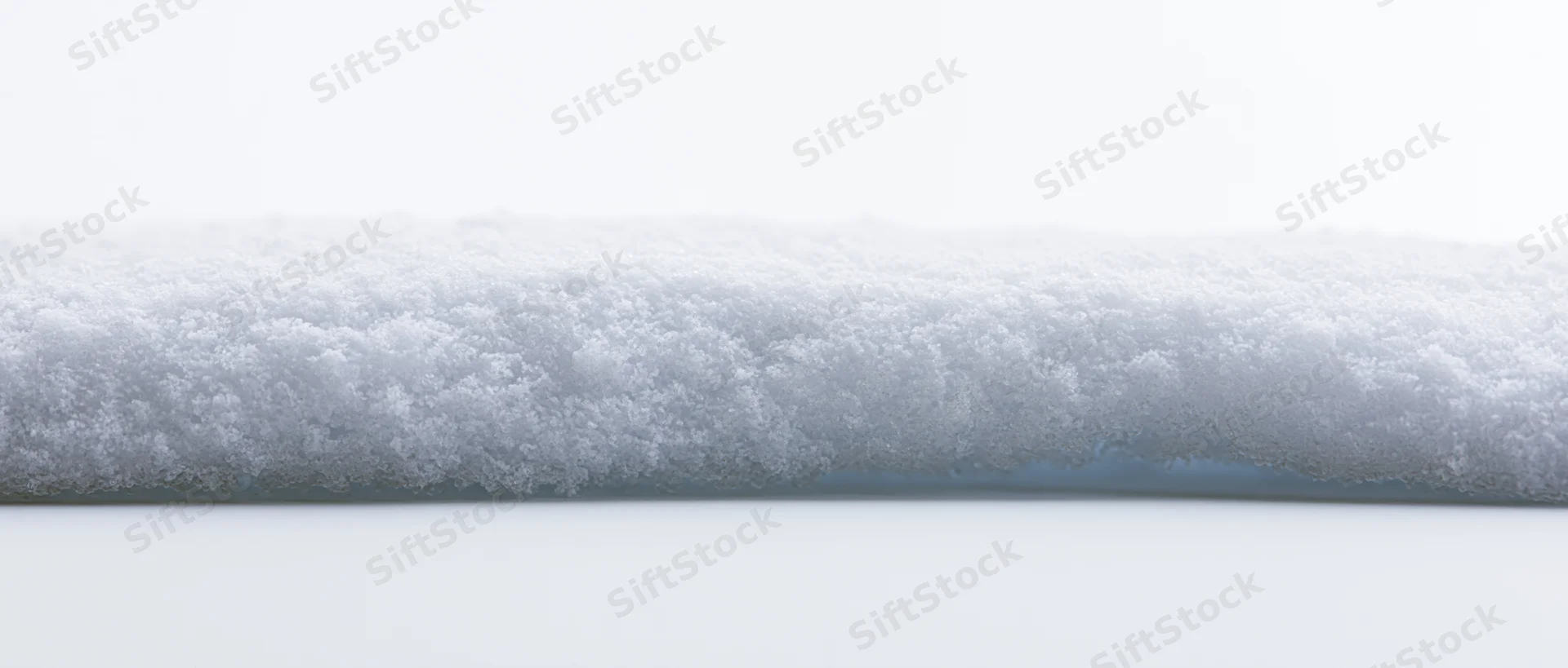 Horizontal snow ridge with crystalline texture isolated on white background
