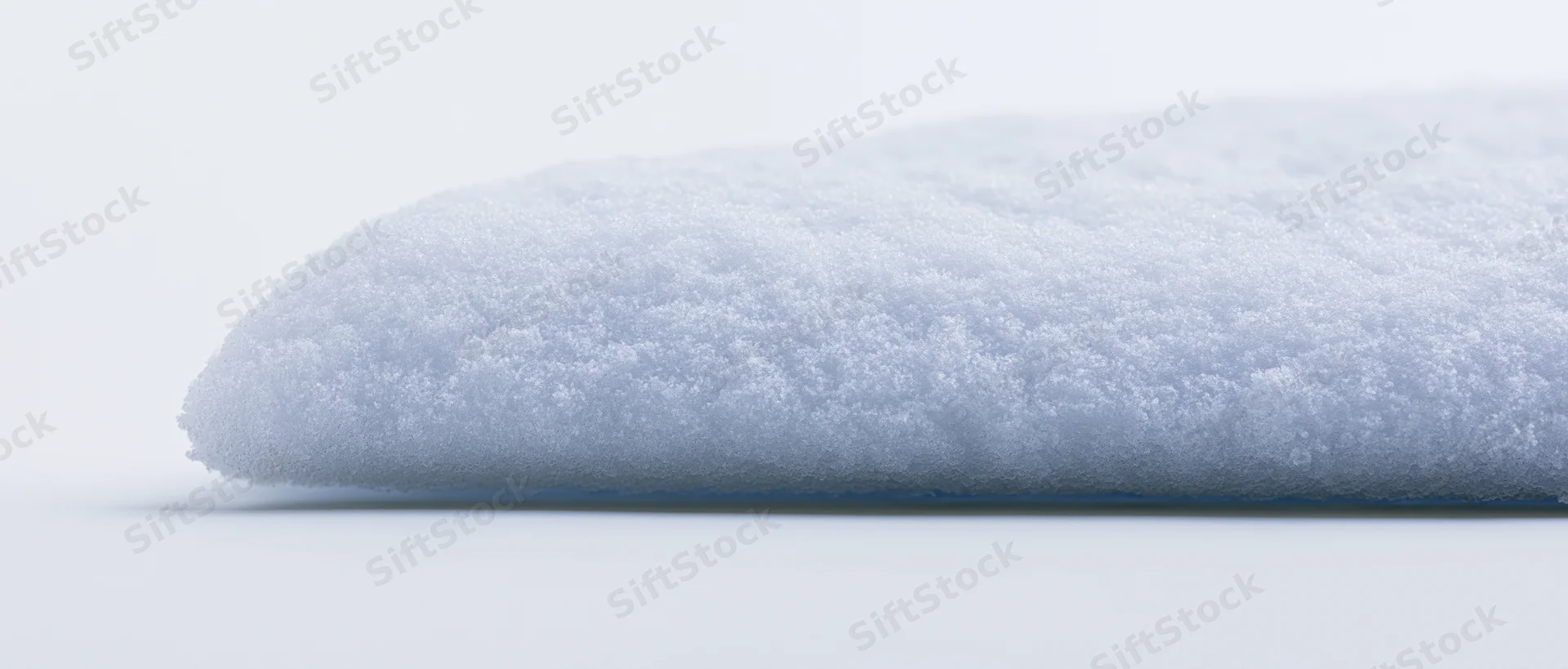 Horizontal ridge of packed snow on a white surface
