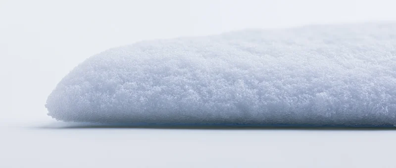 Horizontal ridge of packed snow on a white surface