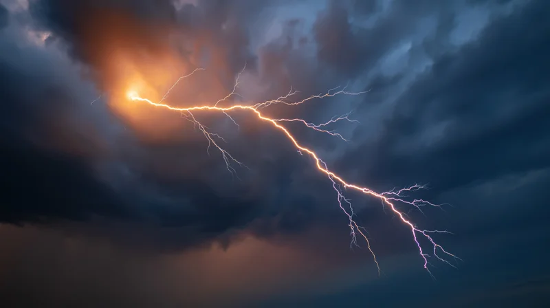 Jagged lightning bolt branching across stormy night sky