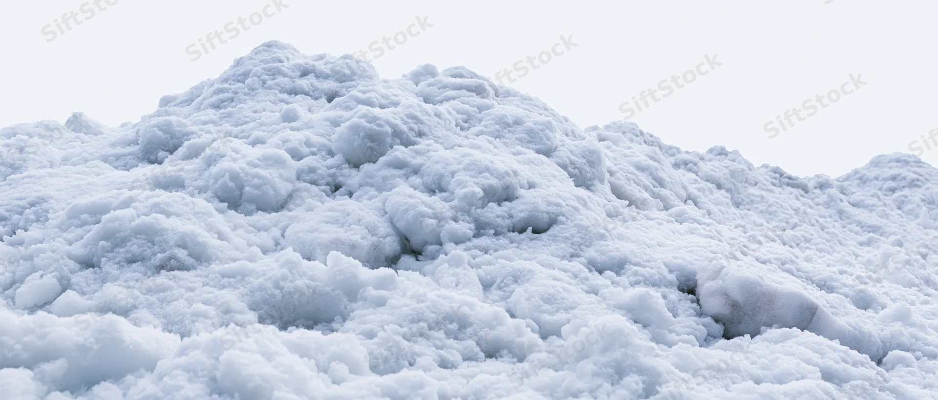 Close-up of a freshly piled snow mound under overcast sky