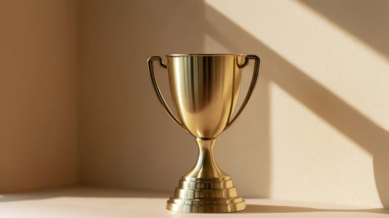 Polished gold trophy cup on a flat surface in a sunlit interior corner