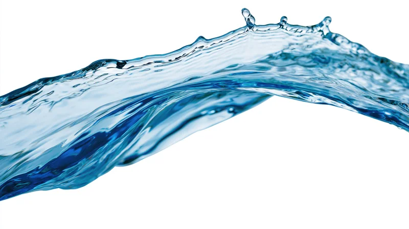 Dynamic water splash frozen mid-motion forming an arcing wave against white background