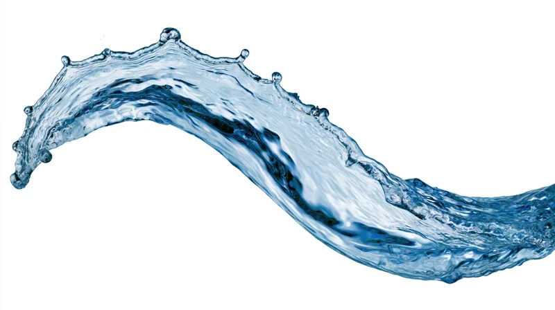 Dynamic water splash frozen mid-motion forming an arc against white background