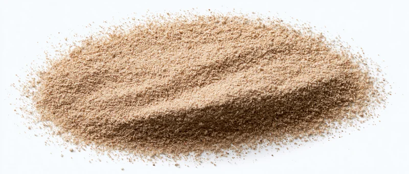 Fine desert sand piled in an elongated heap on a white background