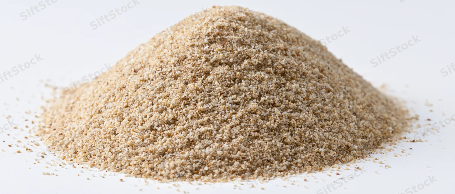 A mound of dry beach sand on a white background