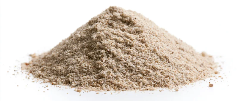 A pile of dry beach sand on a white background