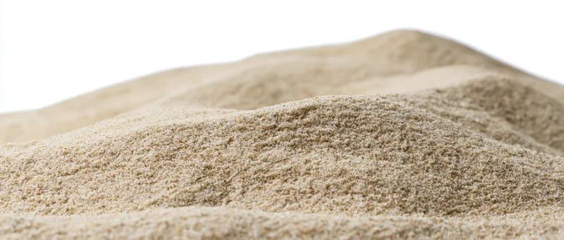 Mound of dry beach sand with undulating surface on white background