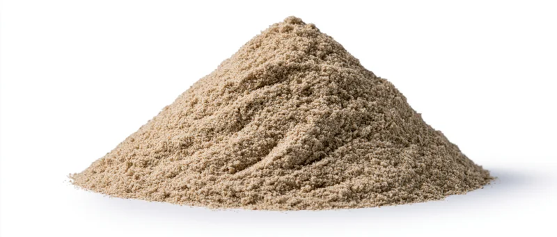 A pile of dry desert sand with natural ridges and peaks on a white background