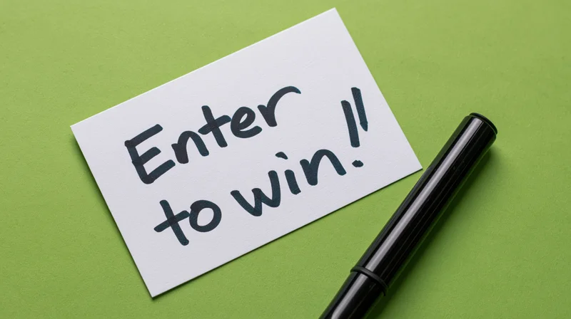 Handwritten note saying enter to win on green background with pen beside it