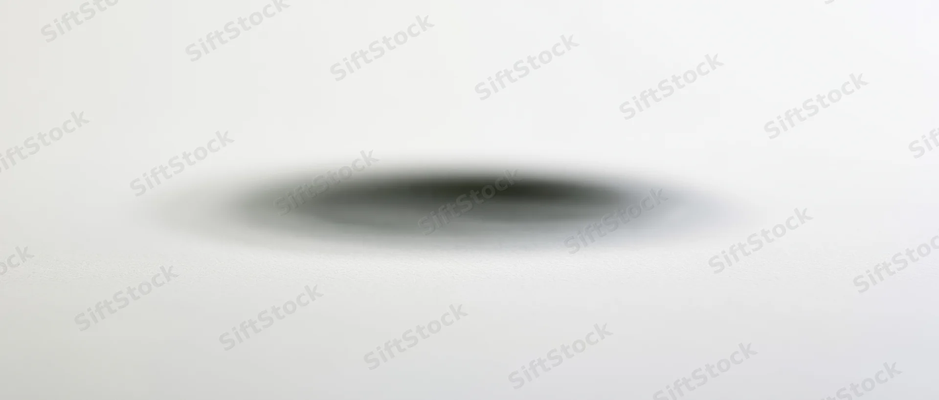 Soft elliptical shadow centered on a plain white background