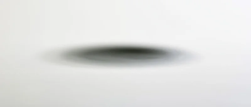 Soft elliptical shadow centered on a plain white background