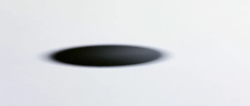 Soft black circular shadow centered on a plain white surface