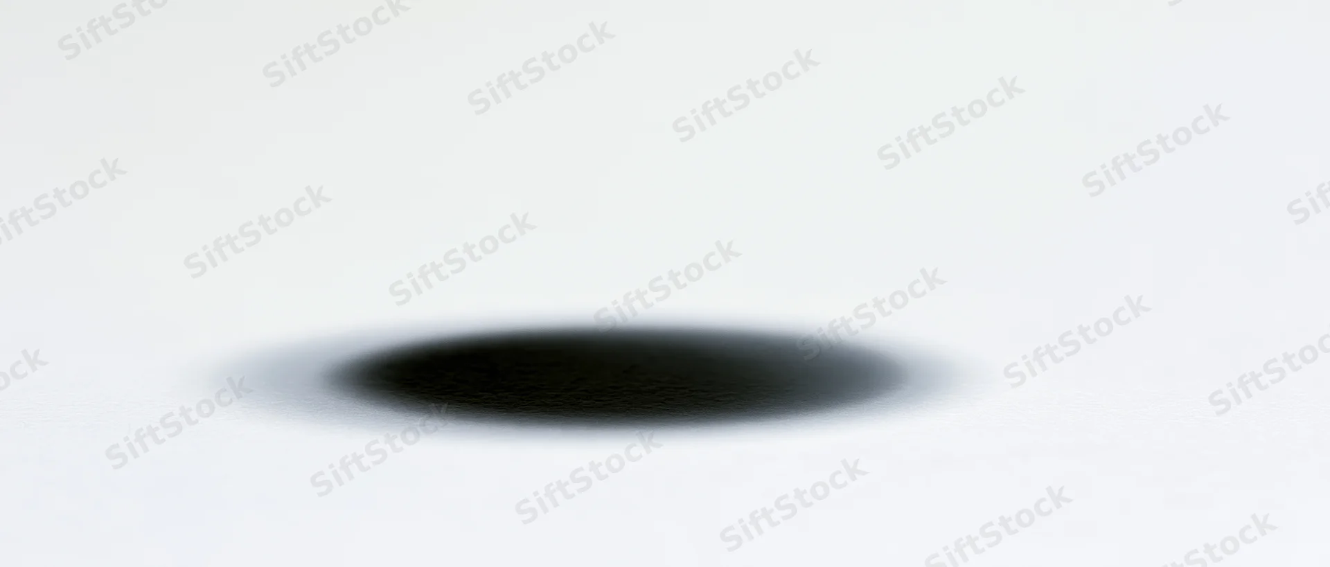 Soft elliptical shadow centered on a plain white background