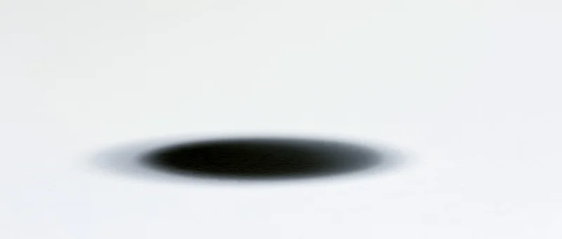 Soft elliptical shadow centered on a plain white background