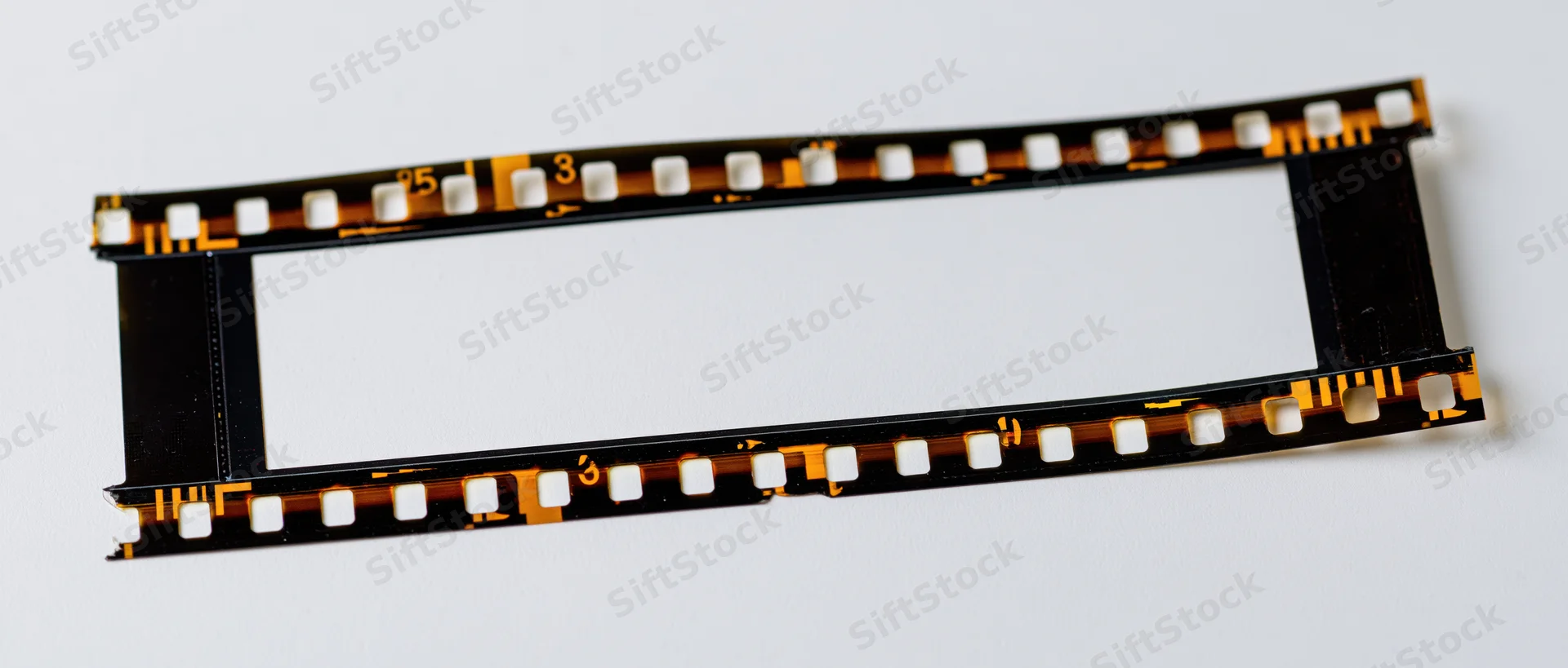 Blank 35mm film strip laid flat on white background